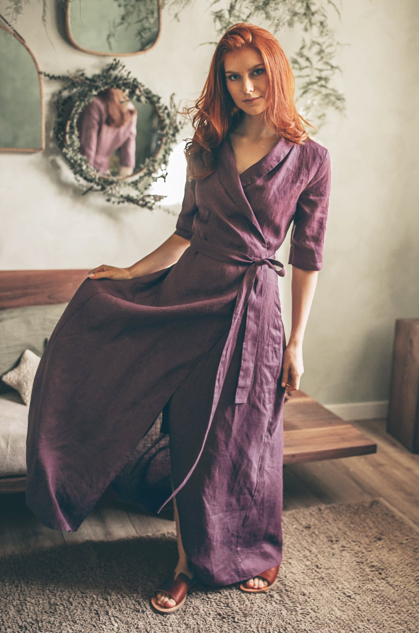 Woman wearing elegant purple linen A-line dress with tie waist in cozy room