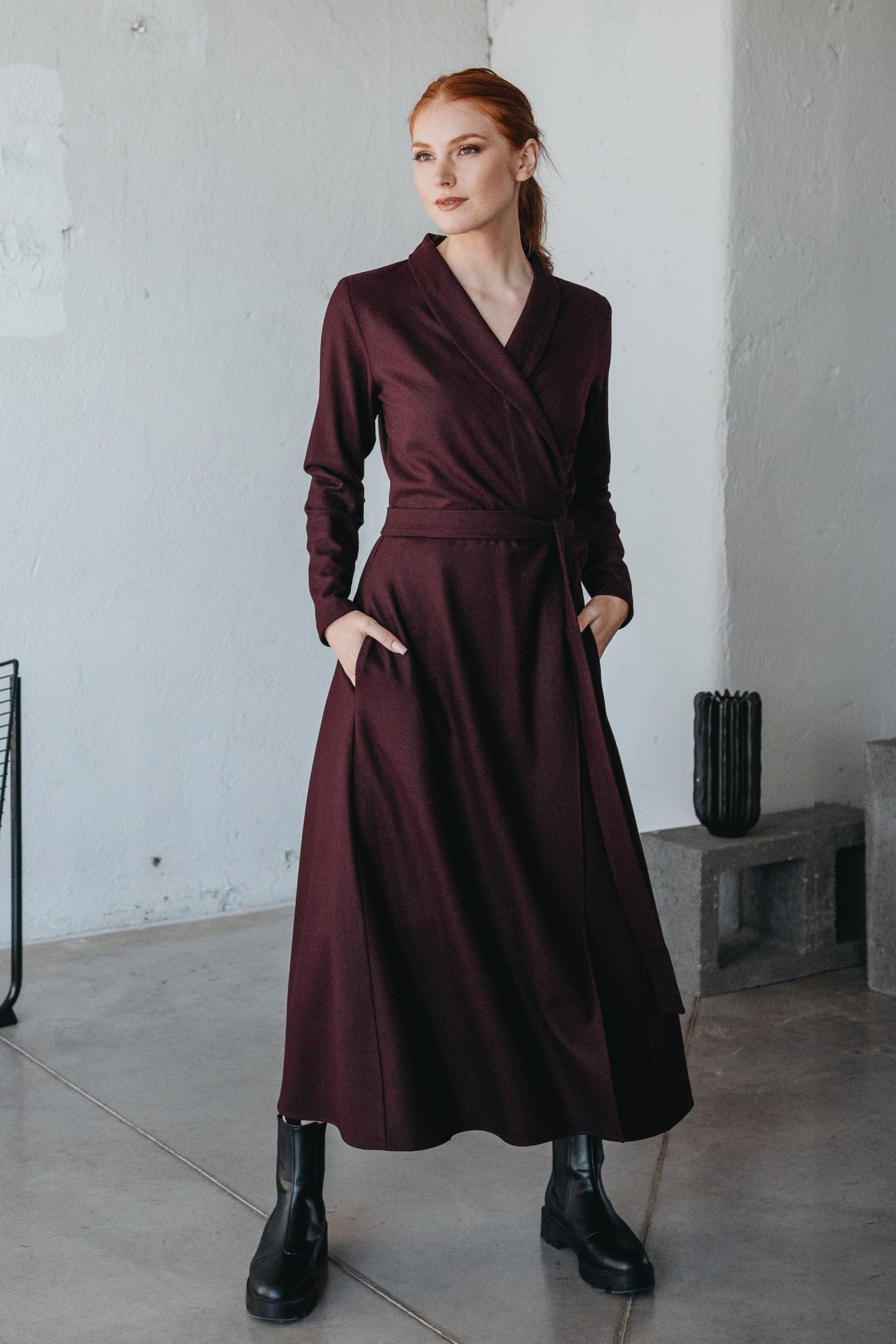 Elegant wool wrap dress with shawl collar and side pockets, perfect for cooler seasons.