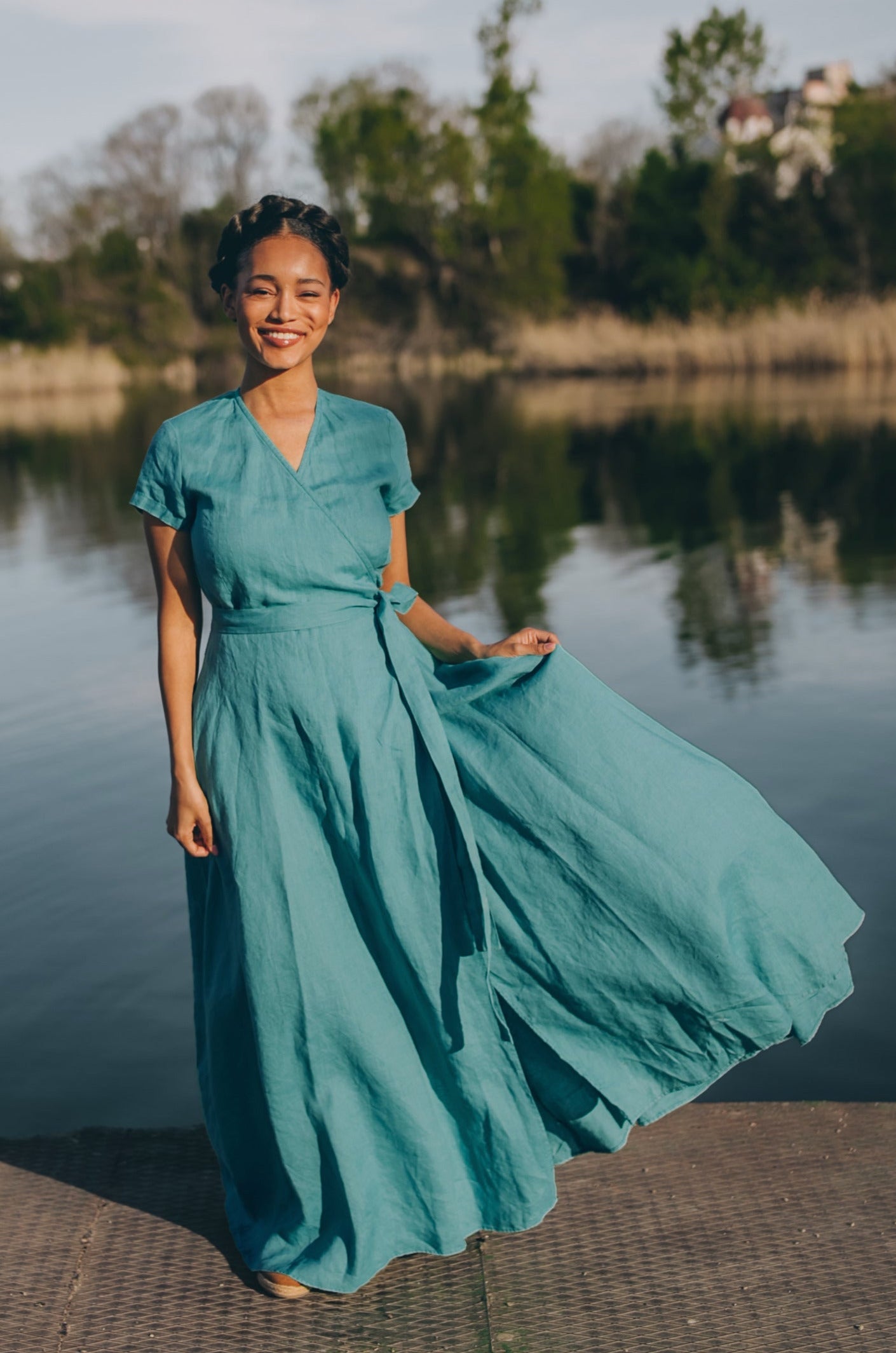 woman wearing short sleeve linen maxi dress with tie waist by the lake