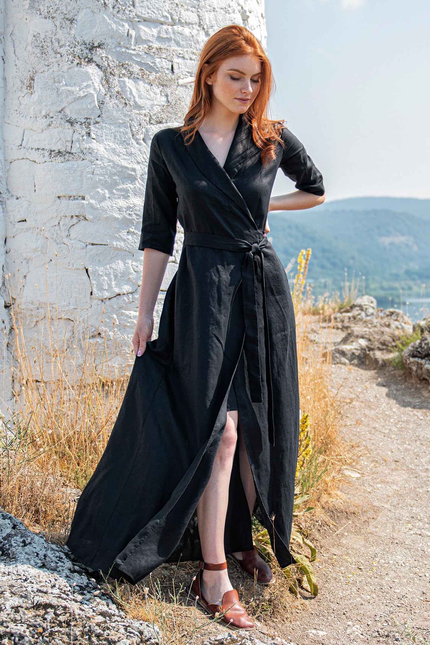 Black linen maxi dress with tie waist and V-neck collar modeled outdoors