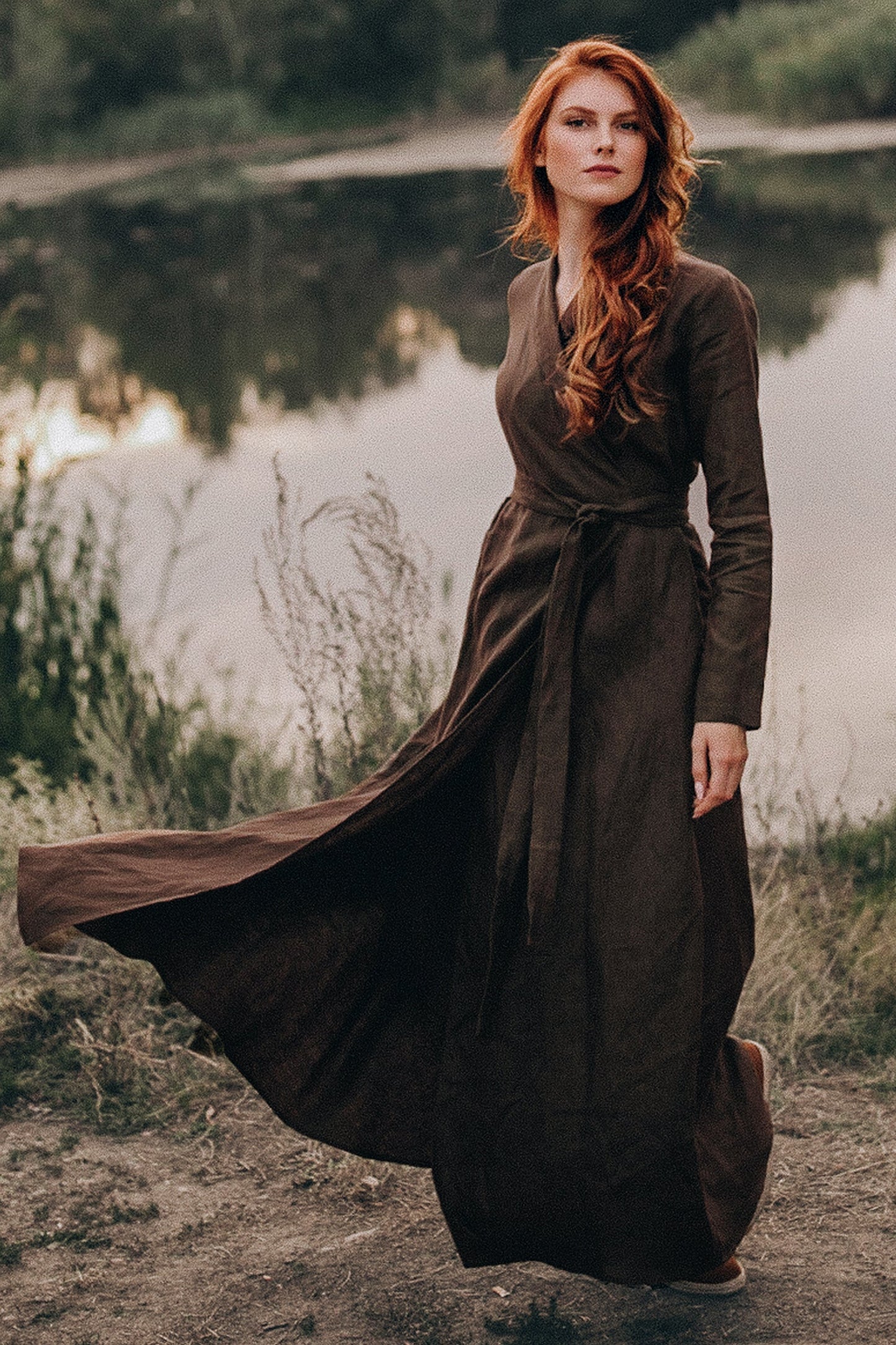 woman wearing chocolate brown linen A-line maxi dress with tie waist outdoors near a lake