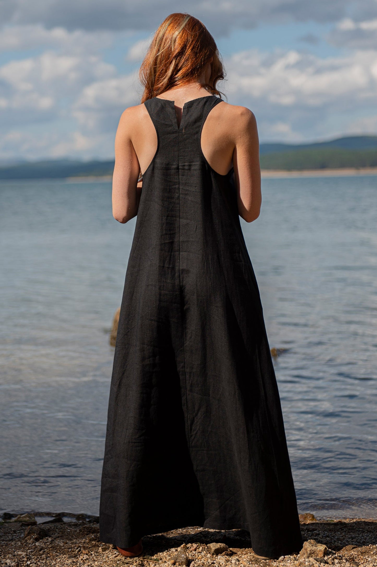 Minimalist long linen black sleeveless maxi dress with halter back by the water