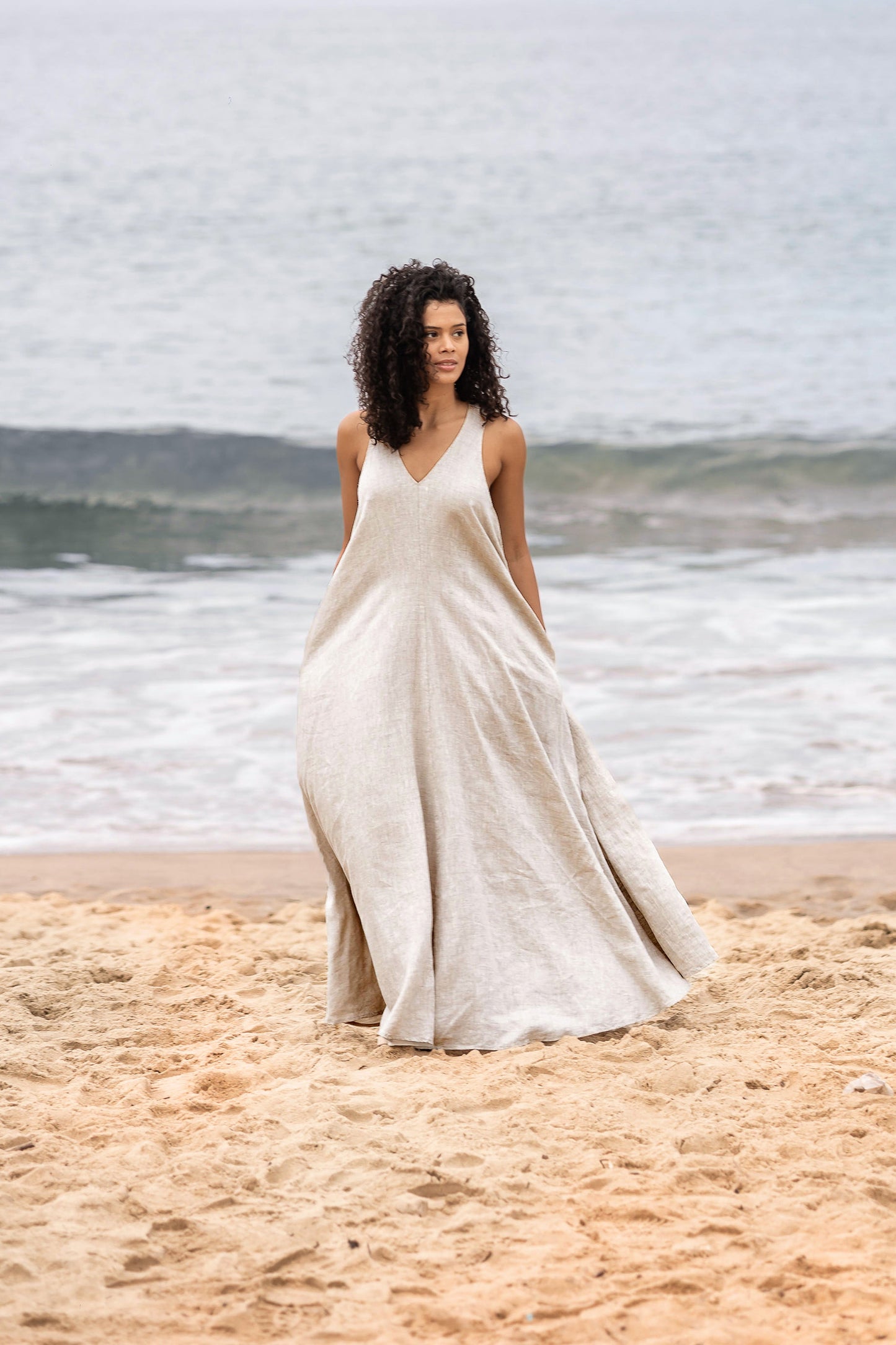 Sleeveless linen maxi dress with halter back and flared bottom in breathable linen