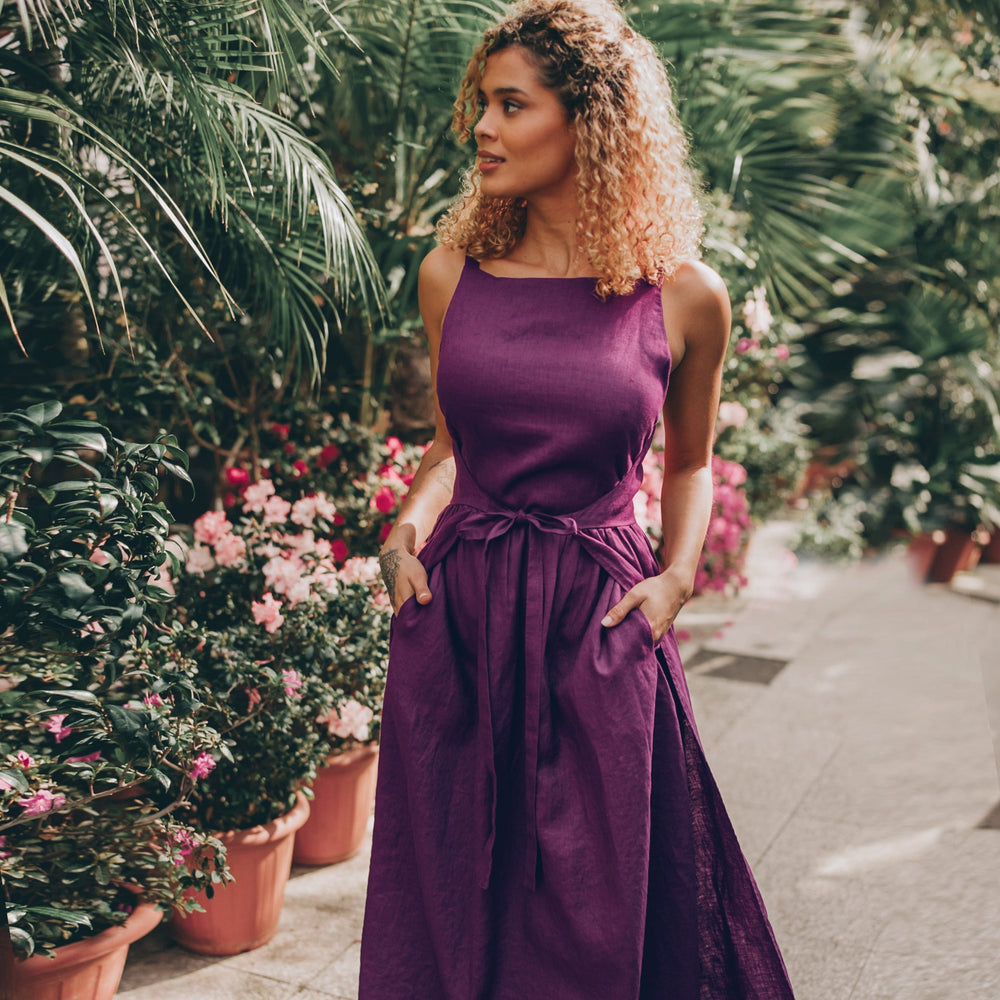 Double wrap linen maxi dress with adjustable waist tie in a garden setting.