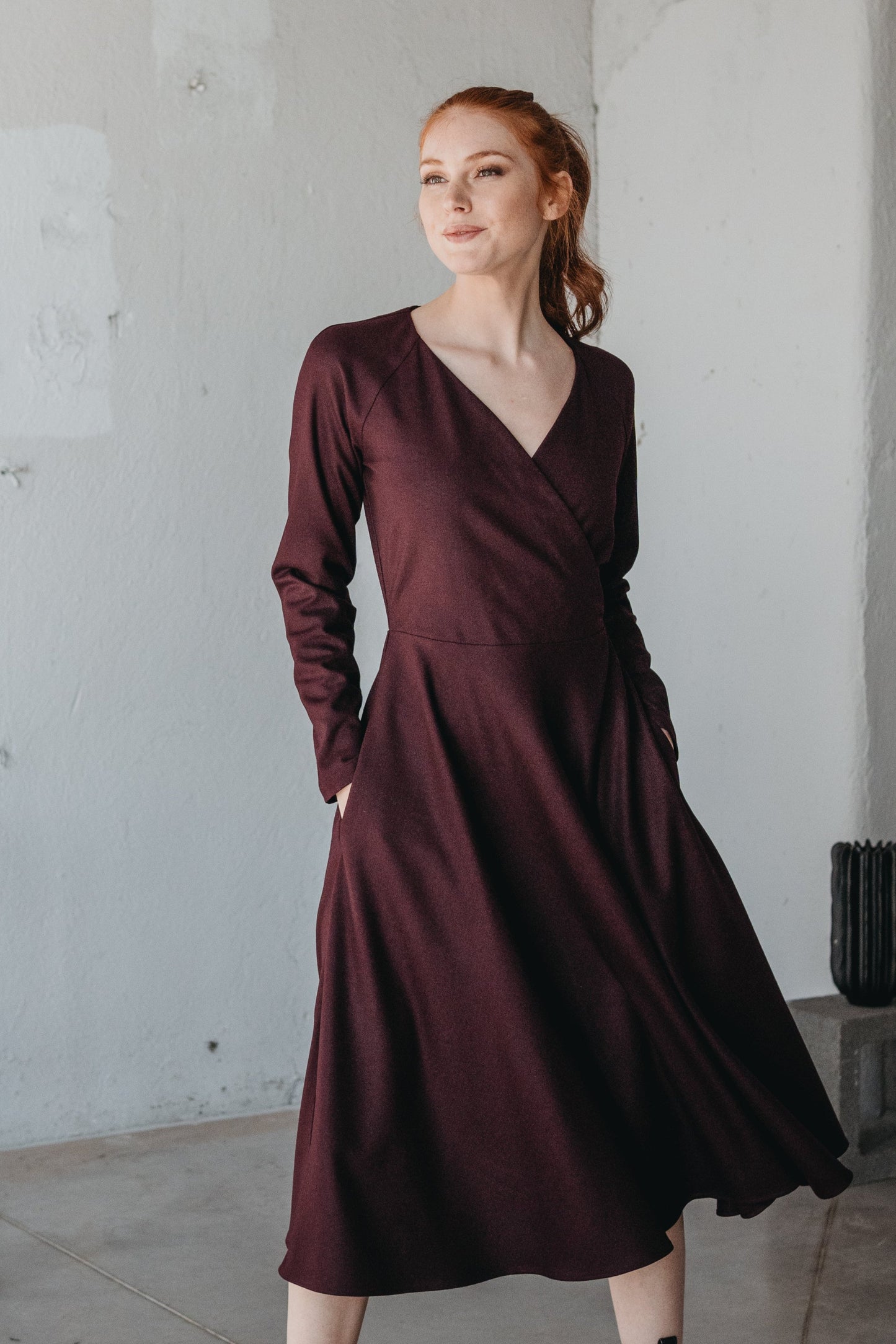 VisibleArt women's midi length wool faux wrap dress with side pockets; burgundy color