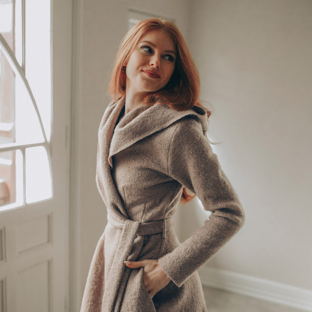 
                      
                        Woman in a Maxi Wool Hooded Cardigan Coat standing in a room with large windows.
                      
                    