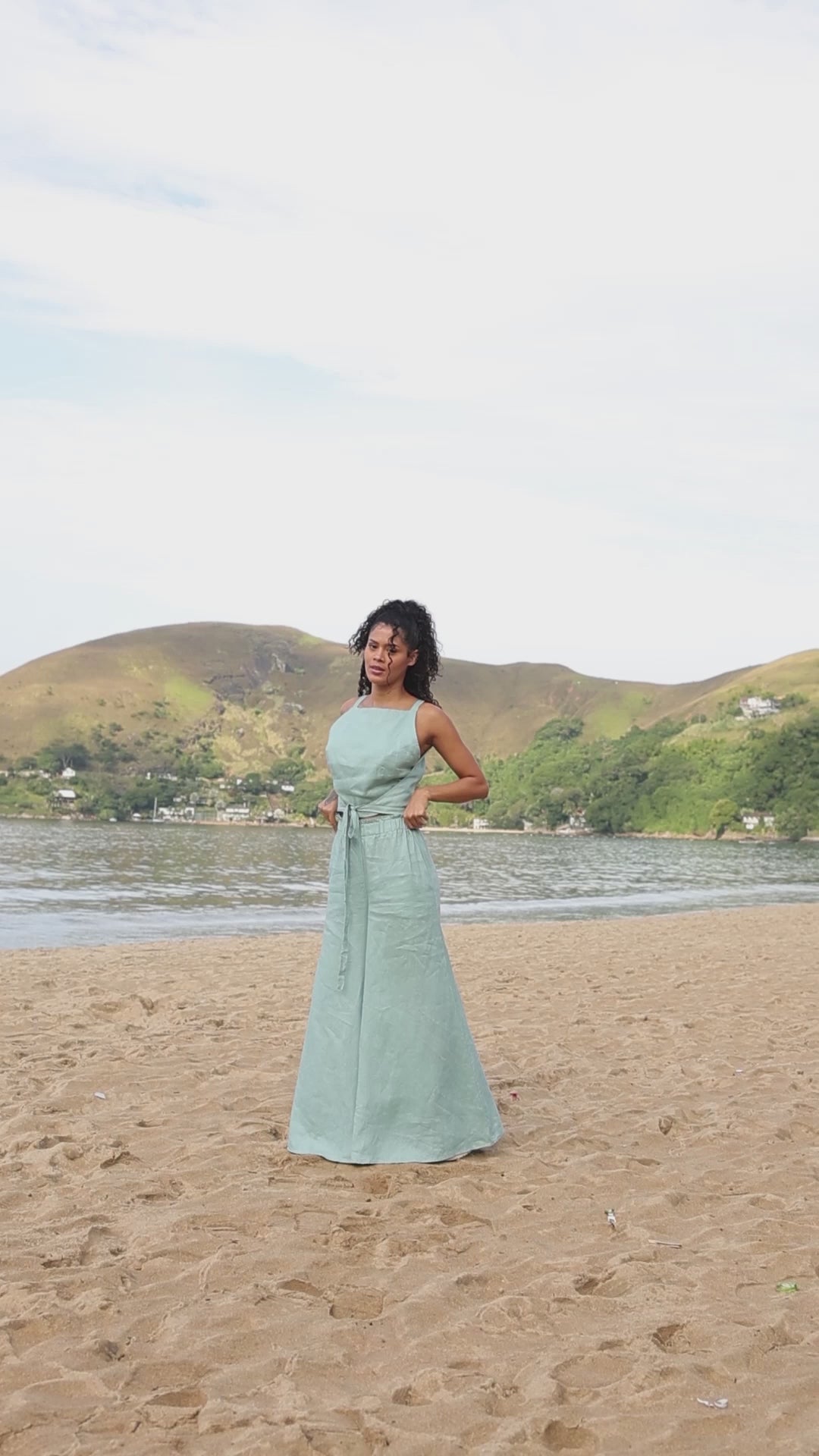 Woman wearing linen wide-leg pants with elastic waist and side pockets