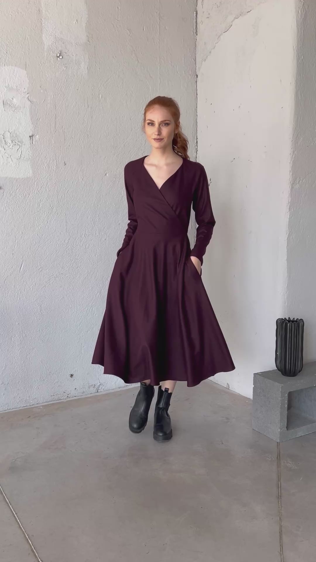 Video of a wool wrap midi dress with a V-neckline, flared skirt, and side pockets, showing the fit and movement of the design.