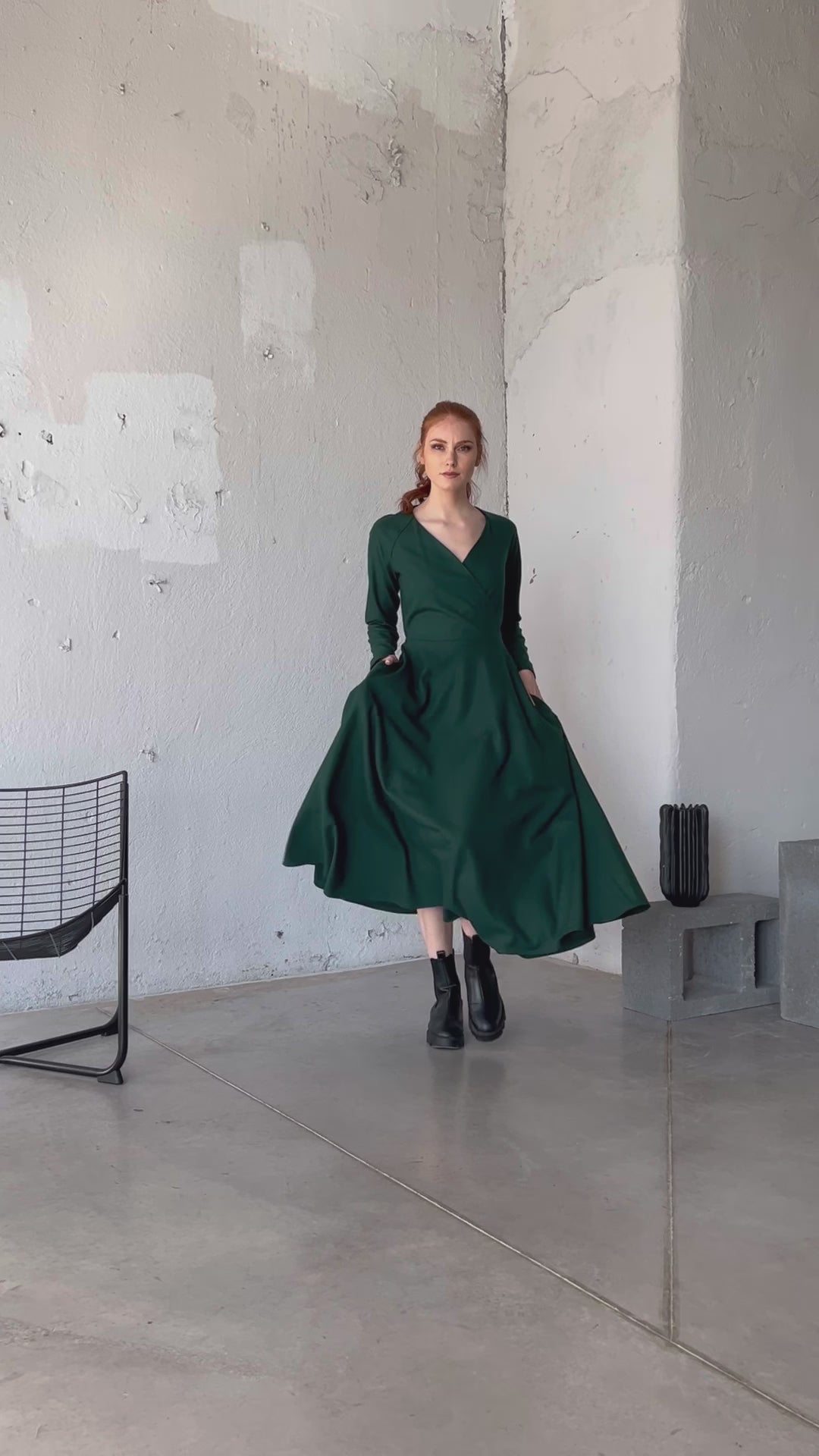 Video of a wool wrap ankle length dress with a V-neckline, flared skirt, and side pockets, showing the fit and movement of the design.