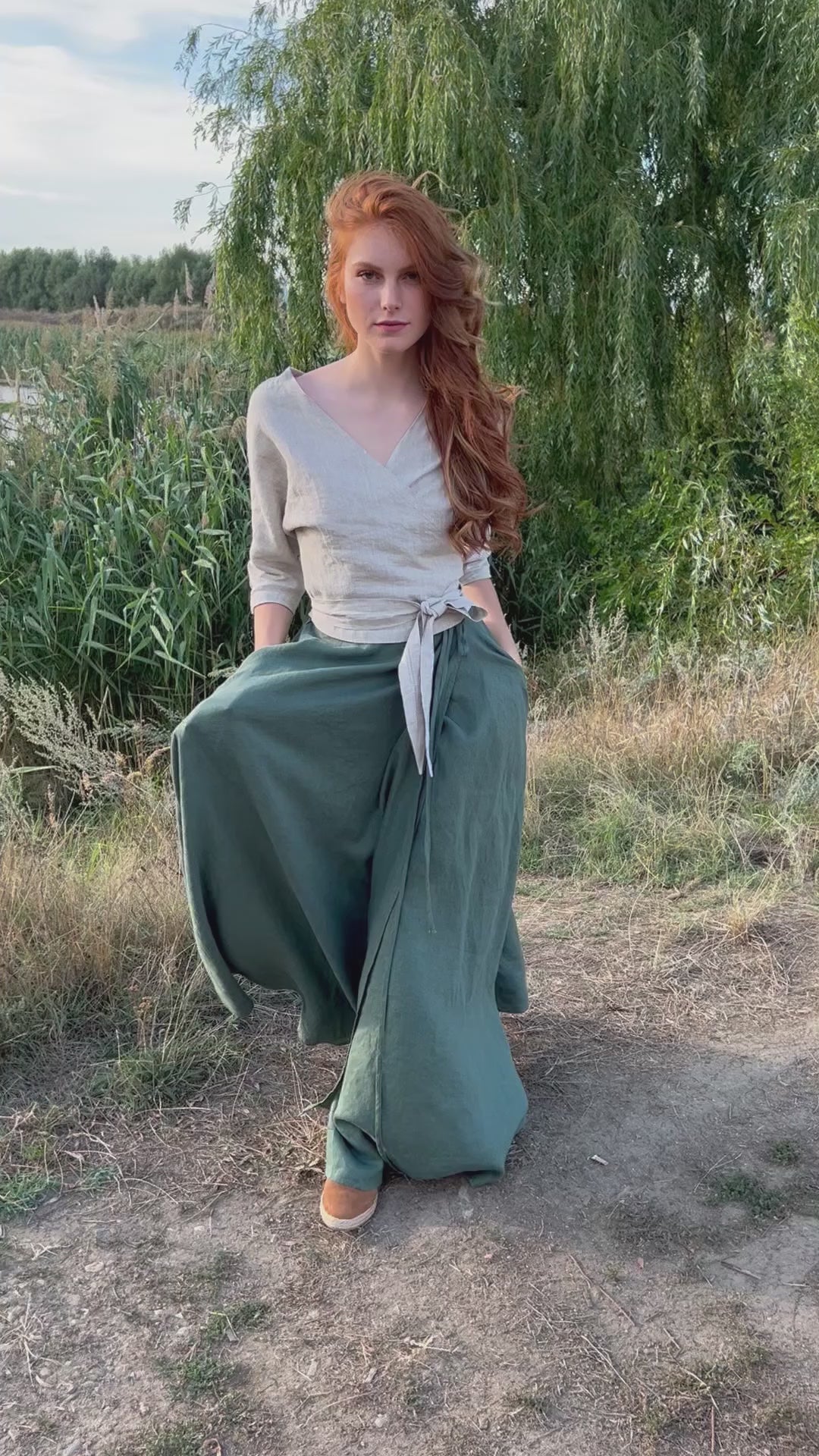 Woman wearing a floor-length linen wrap maxi skirt with side pockets