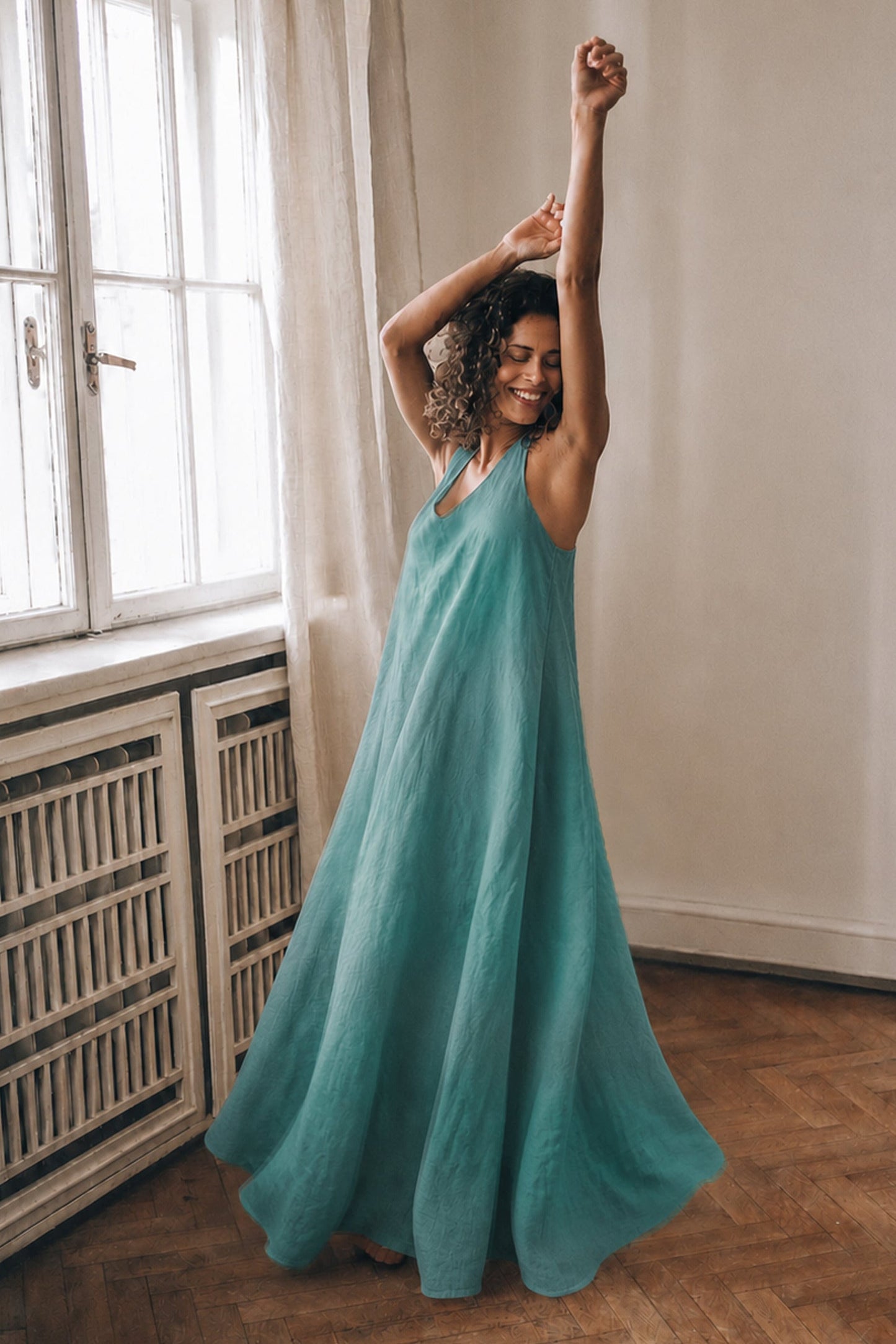 Elegant sleeveless linen maxi dress with halter back and flowing silhouette