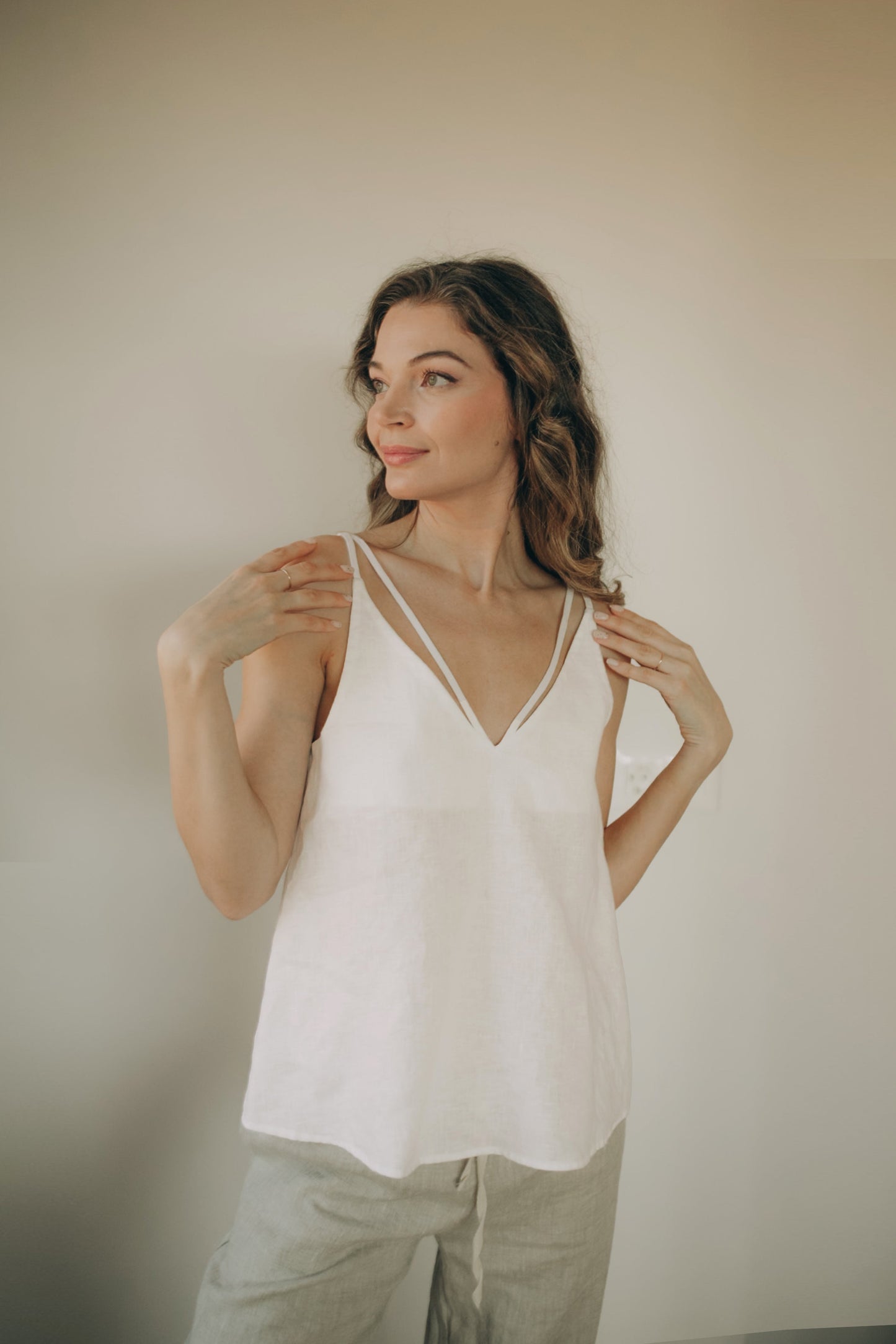 Minimalist linen top with V-neck and cross-back straps, lightweight and breathable summer wear