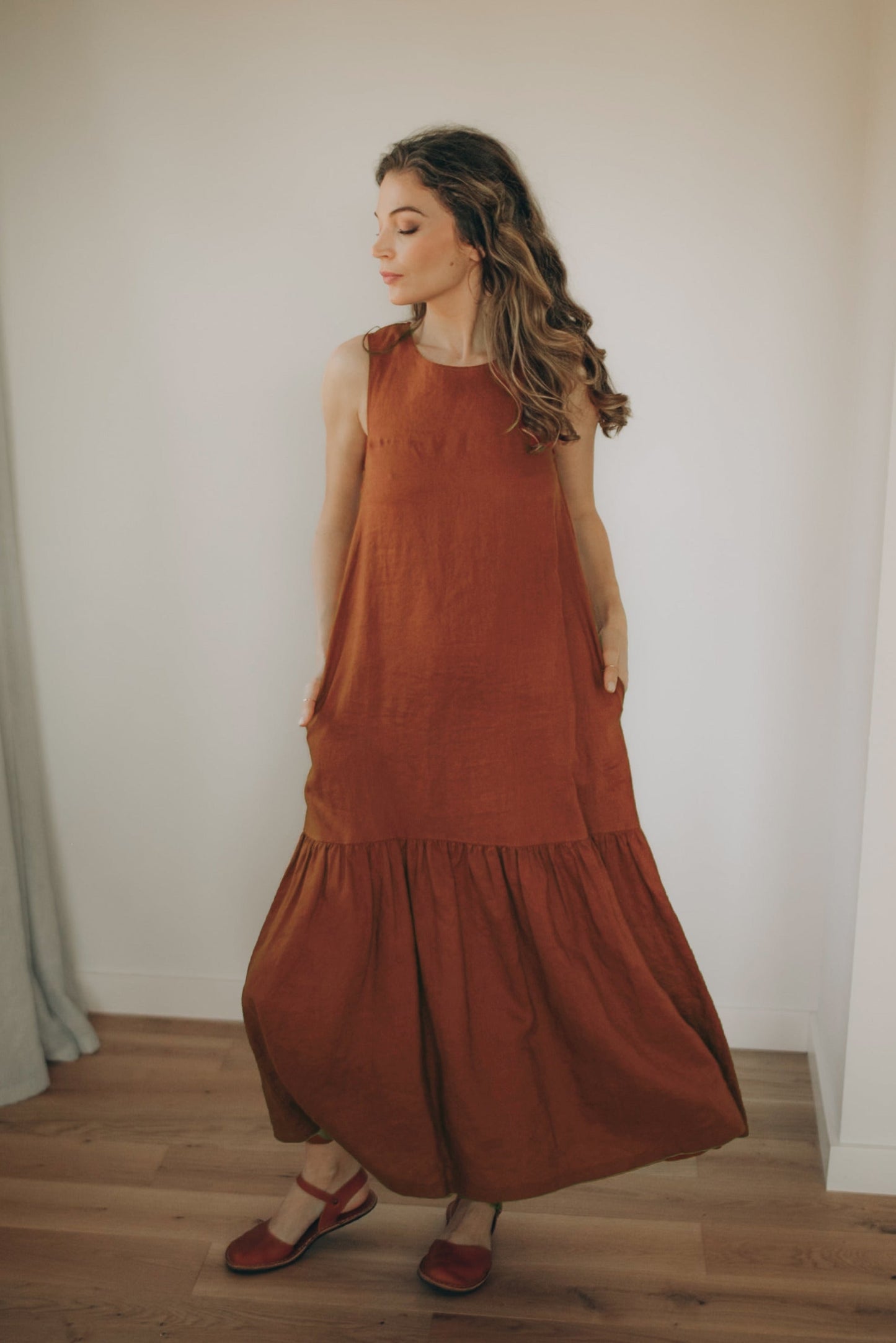 Minimalist linen tiered dress sleeveless midi with flared hem and side pockets